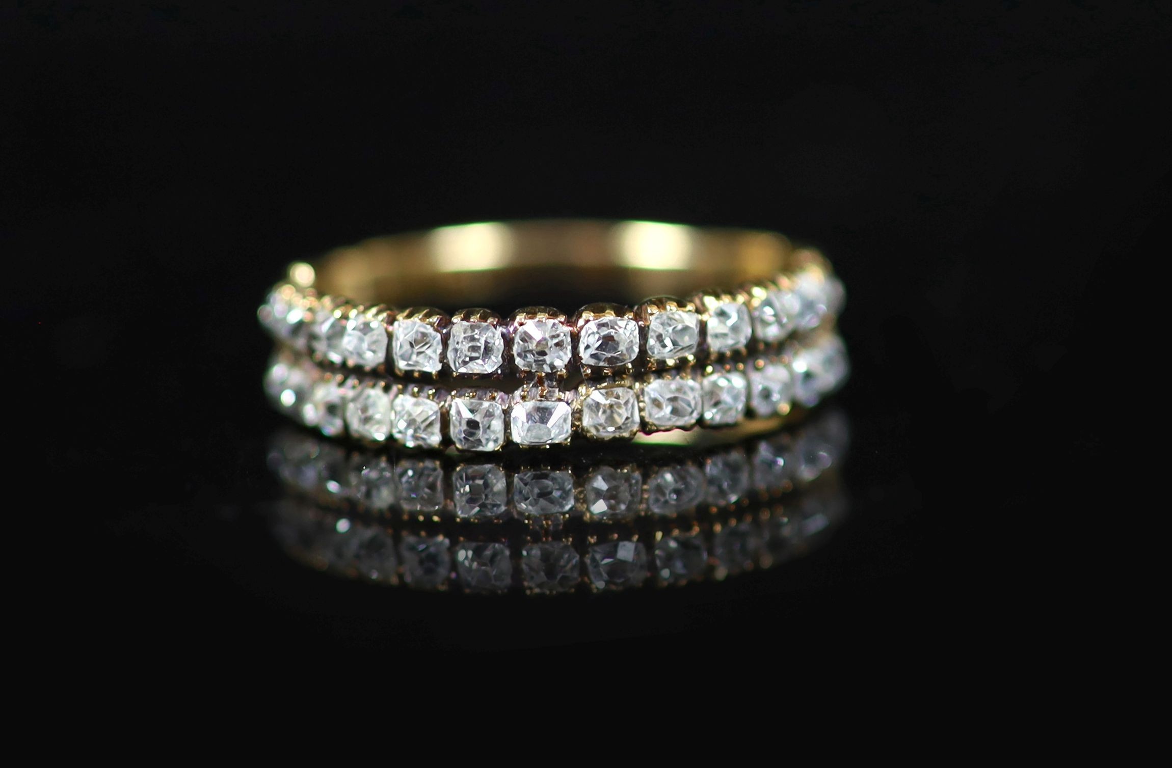 A 19th century gold and twin row old mine cut diamond set half hoop ring